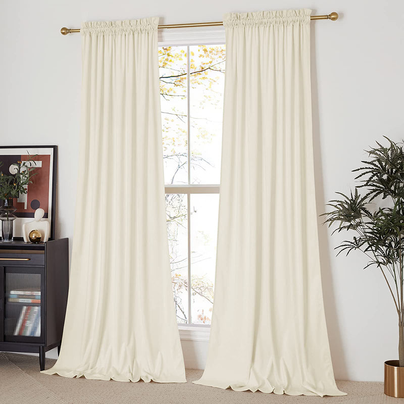 Cream velvet rod pocket blackout curtains providing privacy for a living room or bedroom window. Two panels.