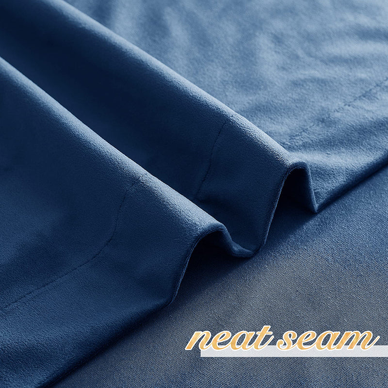 Close-up of a rich deep blue velvet rod pocket blackout curtain, highlighting the fabric's soft texture and a neatly finished seam for privacy.