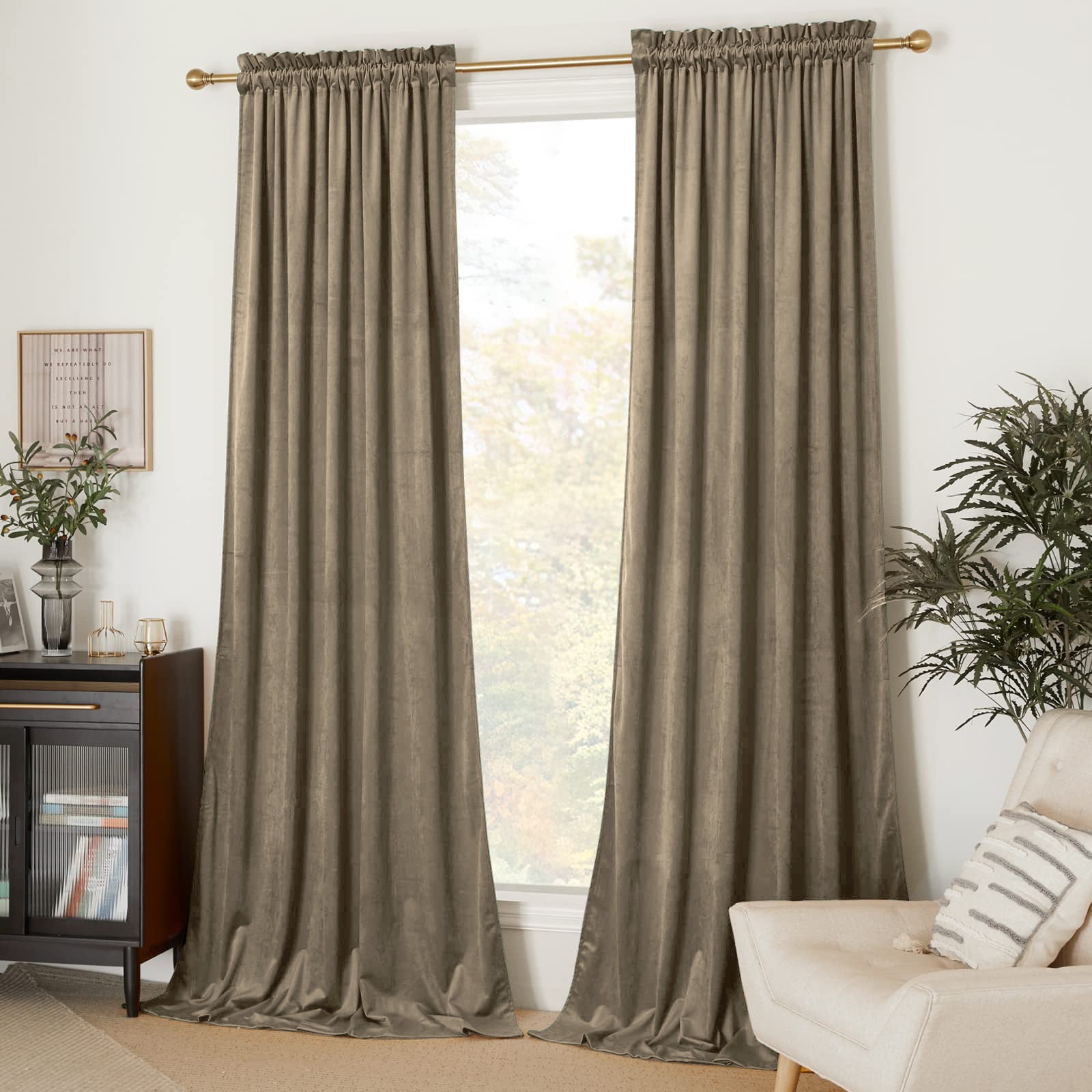Two luxurious taupe velvet rod pocket blackout curtain panels provide living room privacy and light control with elegant drape.
