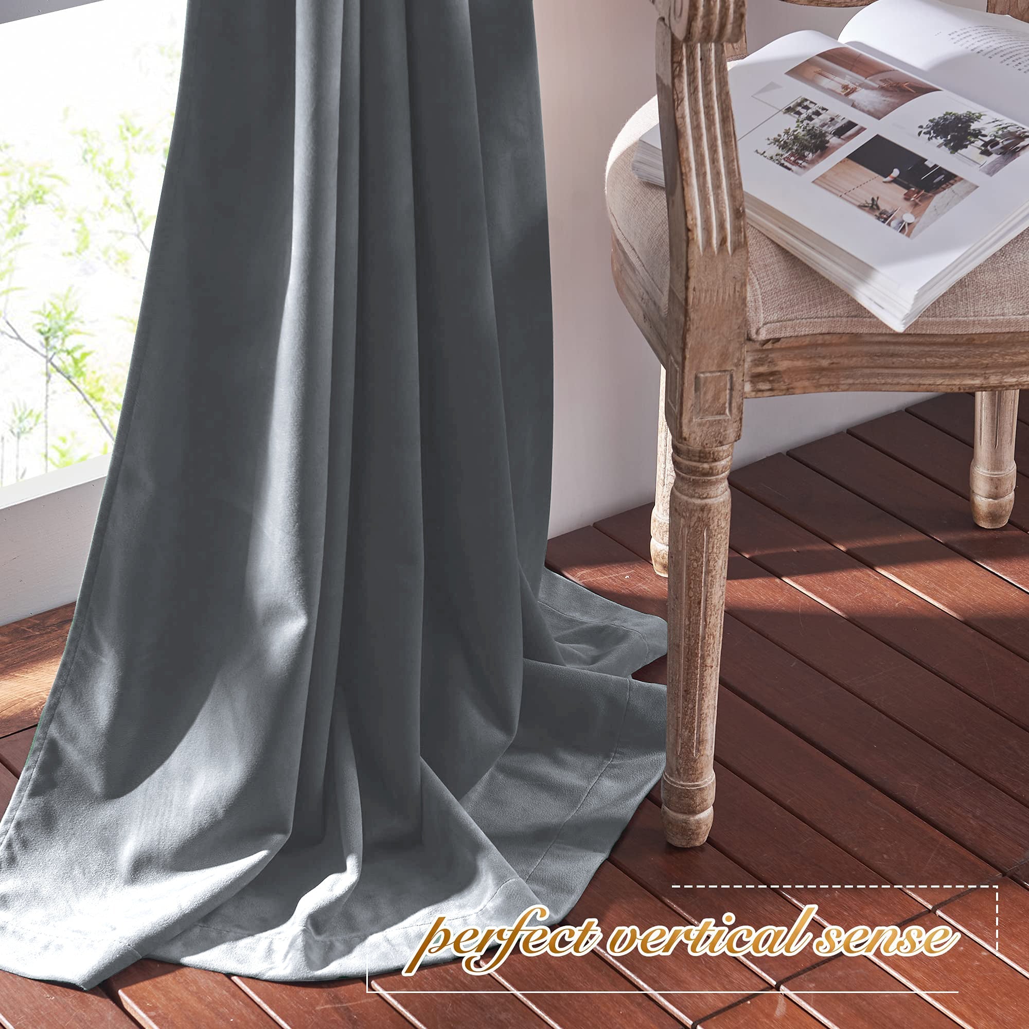 Dark gray velvet blackout curtain panel, ideal for living room or bedroom, draped on wooden floor by a sunlit window.
