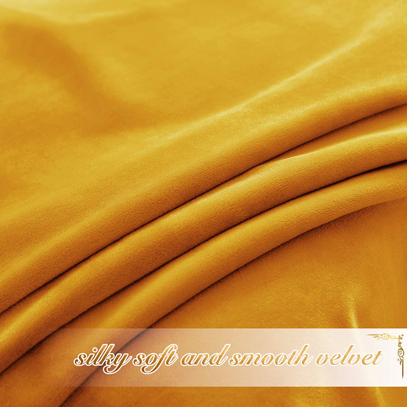 Detailed view of golden yellow velvet fabric with soft folds, showcasing its silky smooth texture for privacy blackout curtains.