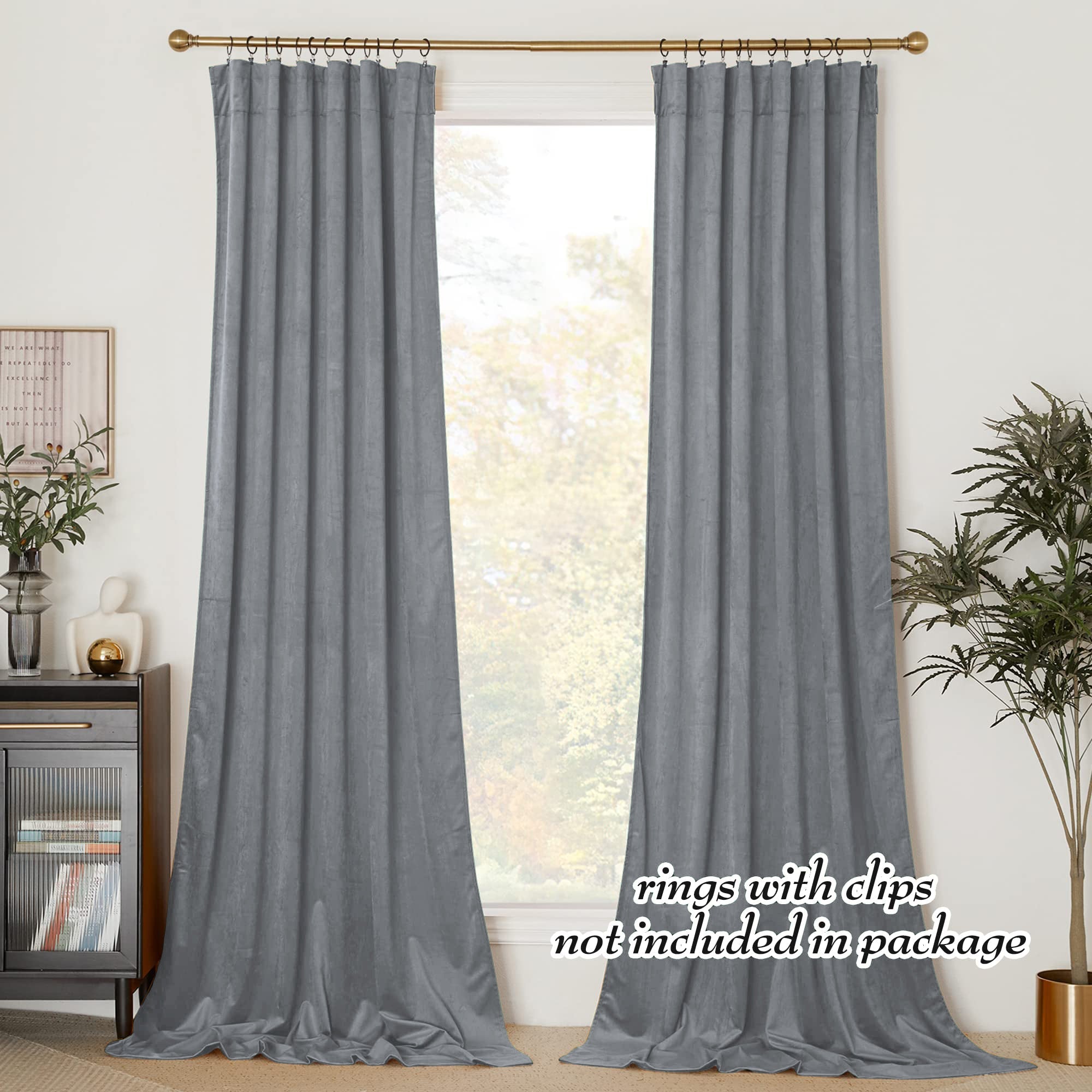 Two gray velvet rod pocket blackout curtain panels hang in a living room, providing privacy and pooling on the floor.