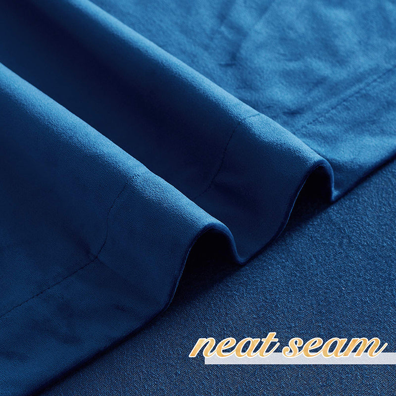 Close-up of deep blue velvet blackout curtain fabric, showcasing soft texture, neat seam, and rod pocket for privacy protection.