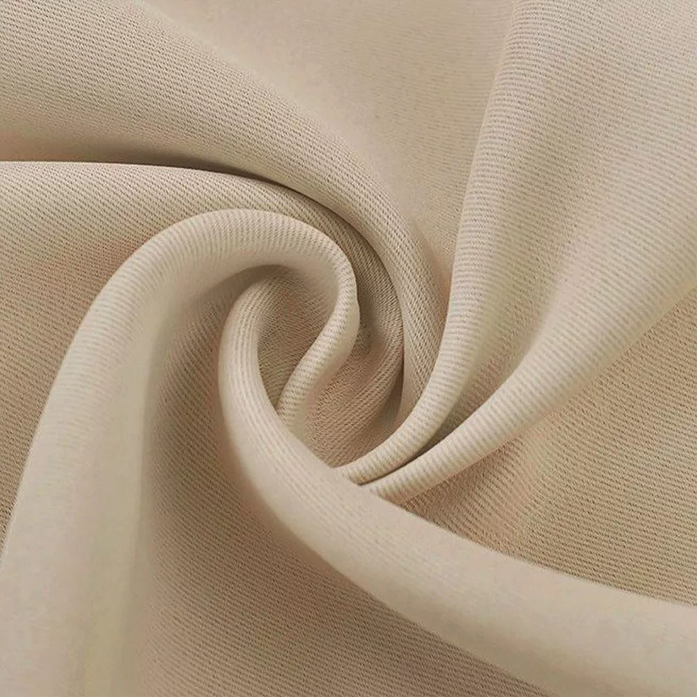 Close-up of thick, textured light beige 4-layer fabric, showcasing material for soundproof, anti-dust blackout curtains.