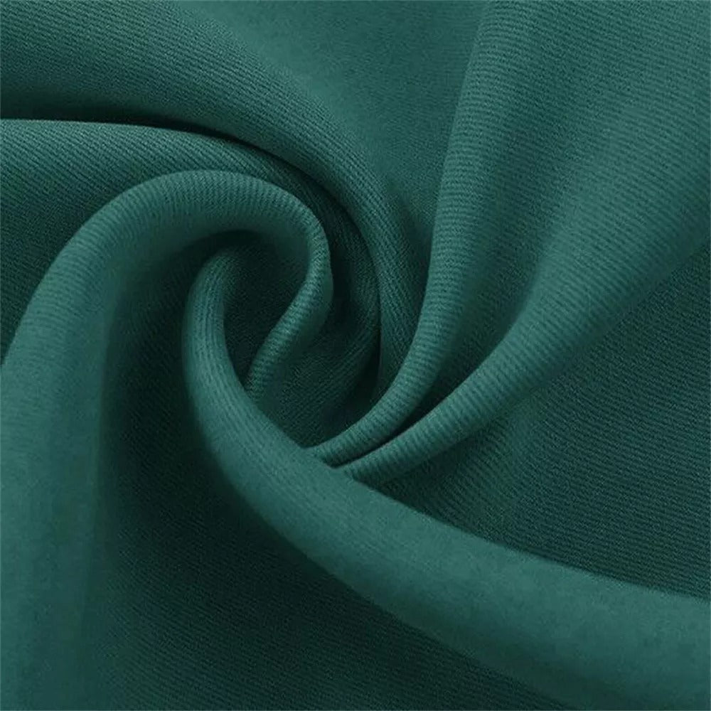 Close-up of folded deep teal 4-layer blackout curtain fabric, highlighting its dense weave and soundproof texture.