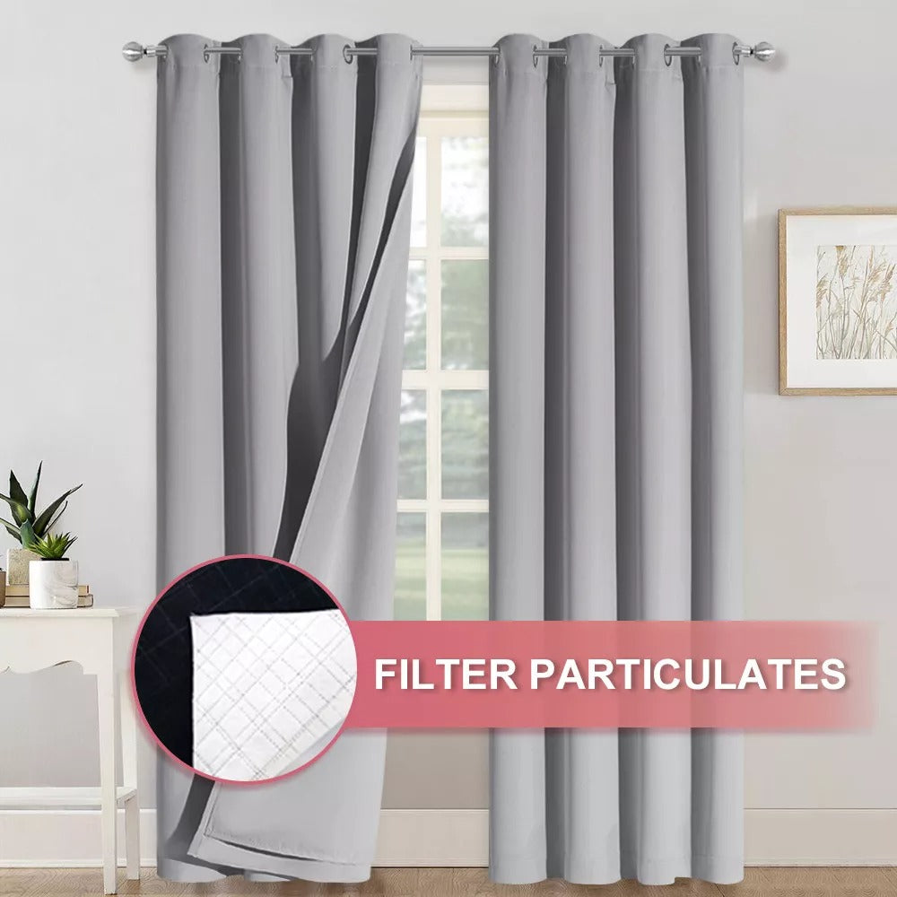 Gray 4-layer silver grommet blackout curtains with one panel revealing its anti-dust particulate filter layer.
