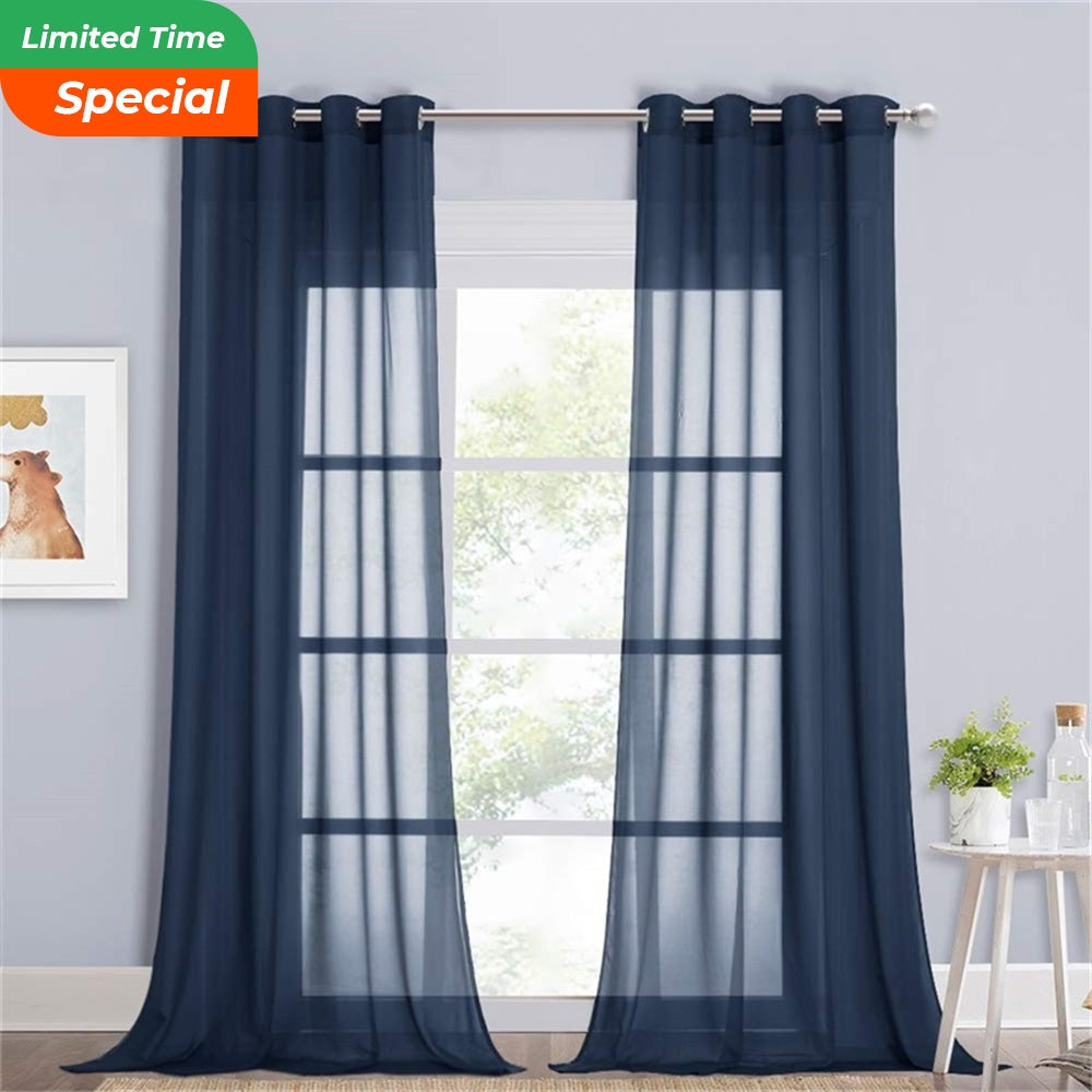 Two dark blue voile sheer privacy curtains with silver grommet tops on a window in a bedroom or living room.