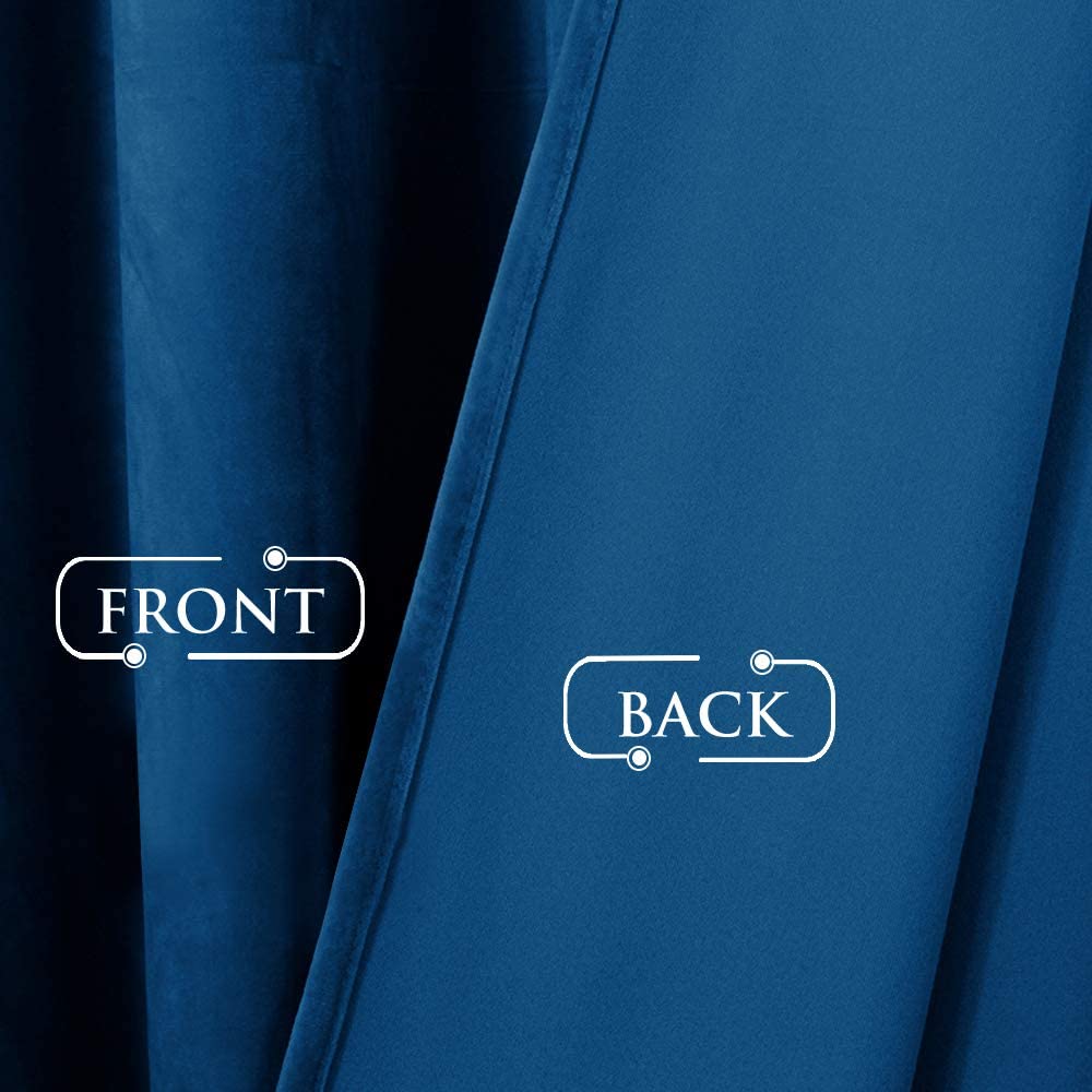 Close-up of rich blue velvet blackout curtain: plush front texture contrasted with smooth blackout back lining.