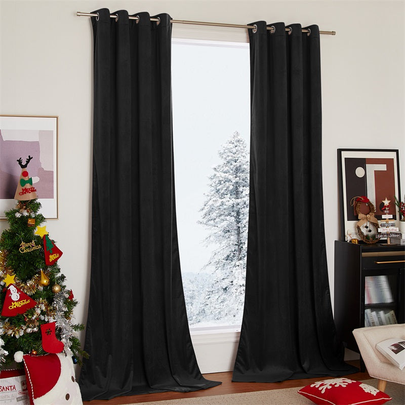 Elegant black velvet blackout curtains with silver grommets (2 panels) framing a snowy window in a cozy, Christmas-decorated living room.
