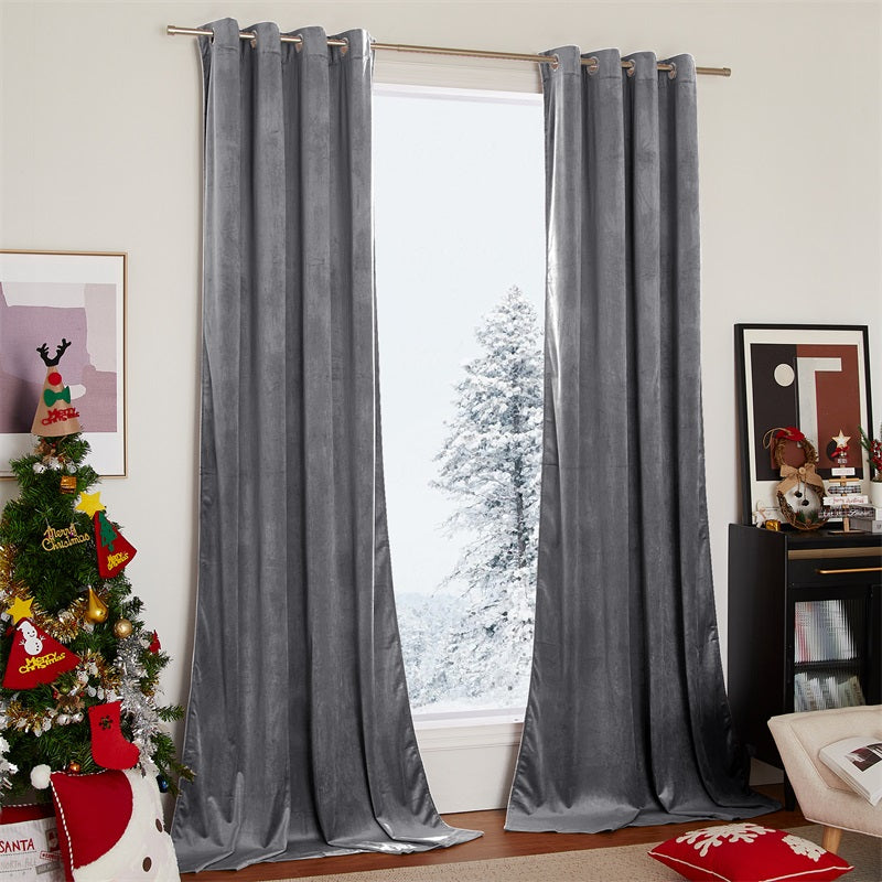 Two panels of luxurious grey velvet blackout curtains with silver grommets for a living room or bedroom, set against a snowy window.