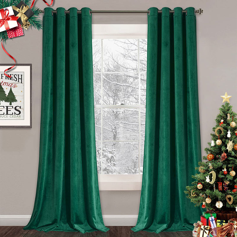 Two panels of emerald velvet blackout curtains with silver grommets for living room, beside a snowy window & Christmas tree.