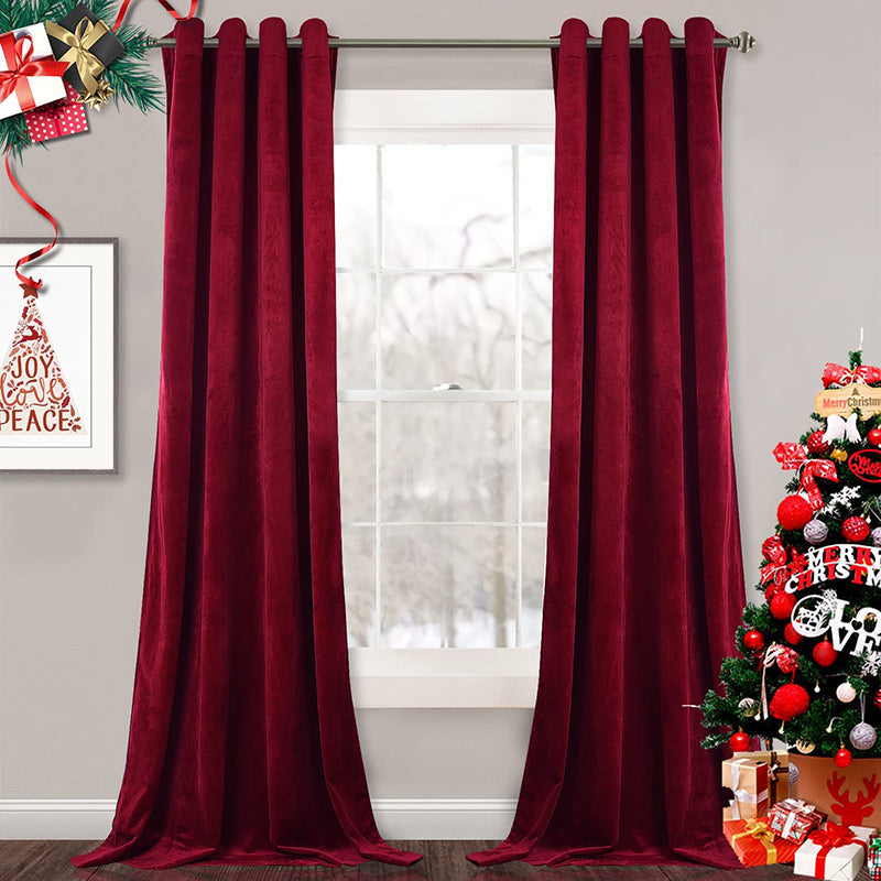 Two plush burgundy velvet blackout curtain panels with silver grommets, ideal for living room or bedroom privacy.