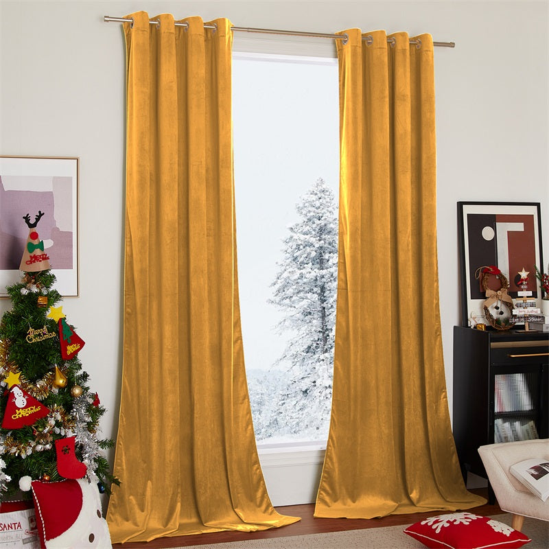 Golden velvet blackout curtains, 2 panels, with silver grommets, hanging in a living room window with a snowy view.