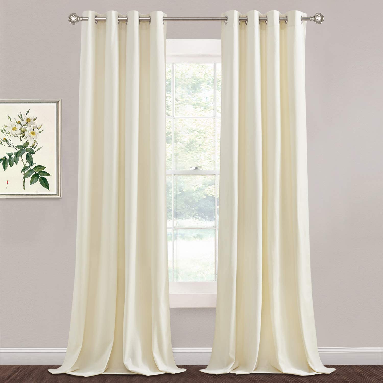 Two cream velvet blackout curtain panels with silver grommets hanging over a window, perfect for living room or bedroom.