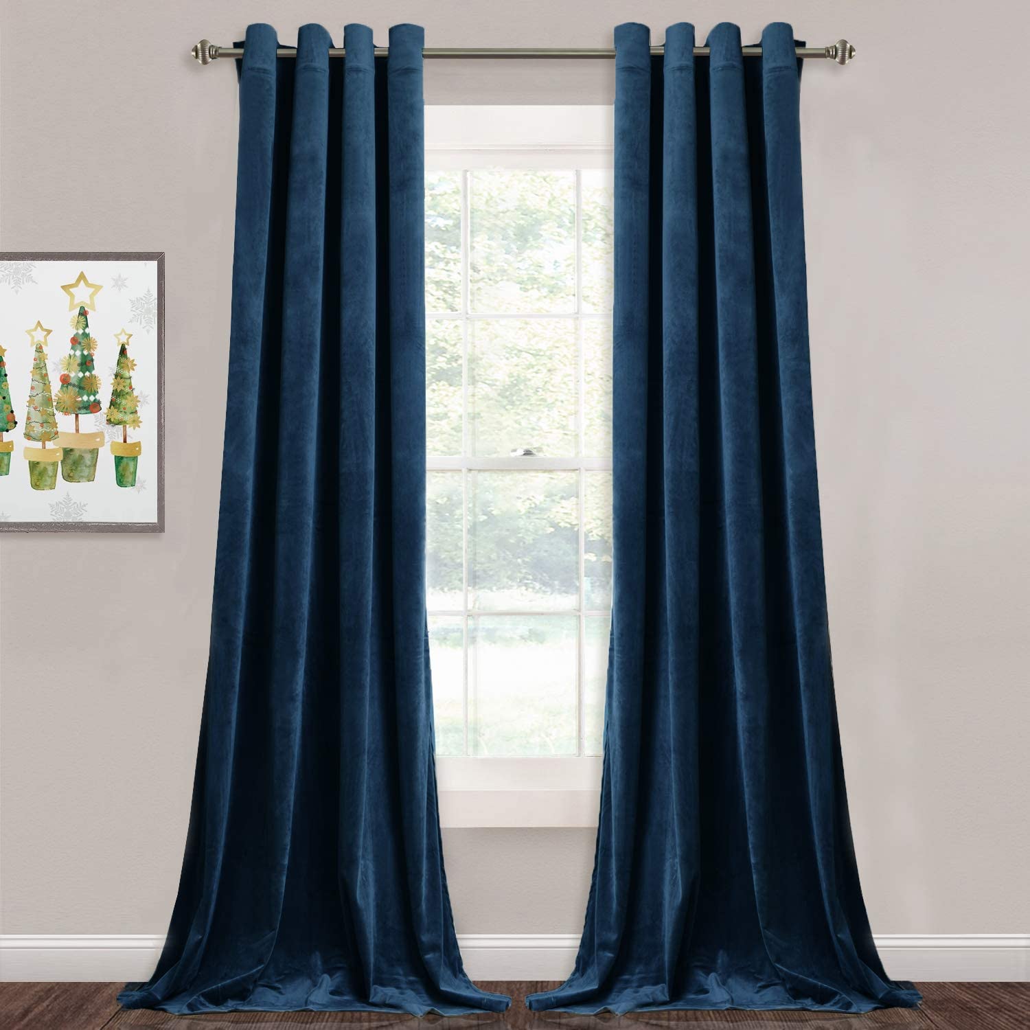 Two panels of deep teal velvet blackout curtains with silver grommets, open to frame a window in a contemporary living space.