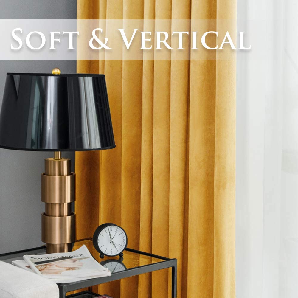 Rich gold velvet blackout curtain panels with soft vertical pleats, enhancing a living room or bedroom.