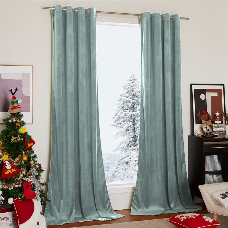 Two panels of light green velvet blackout curtains with silver grommets, ideal for living room or bedroom with a snowy view.