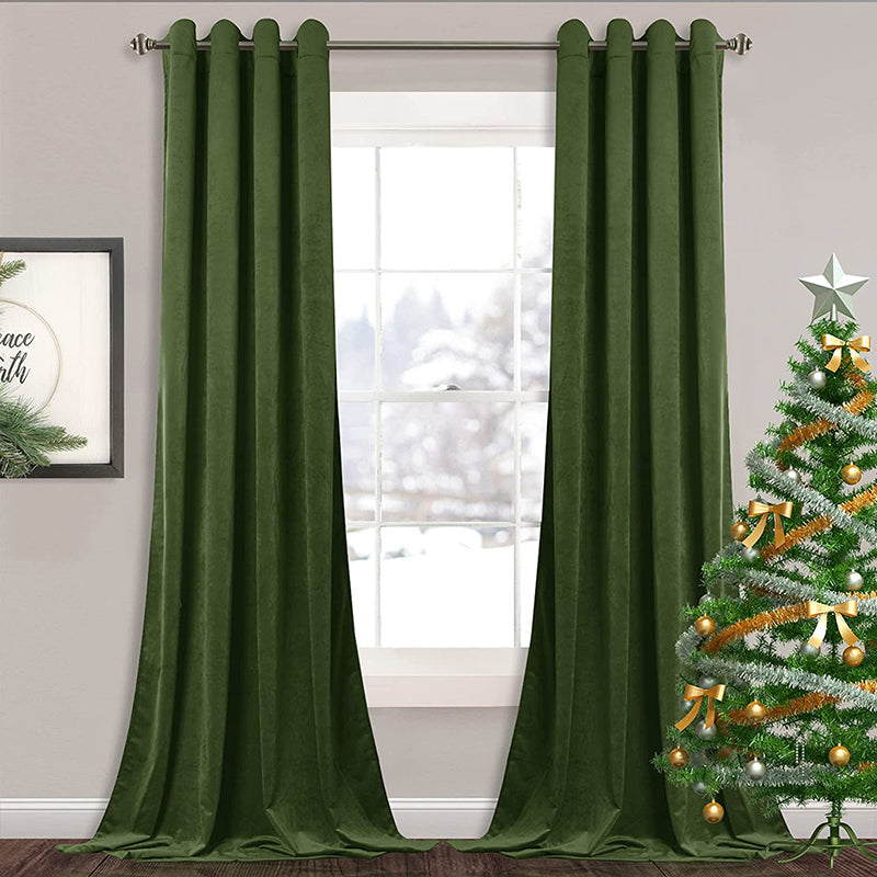 Two olive green velvet blackout curtain panels with silver grommets, partially open on a living room window, with a Christmas tree.