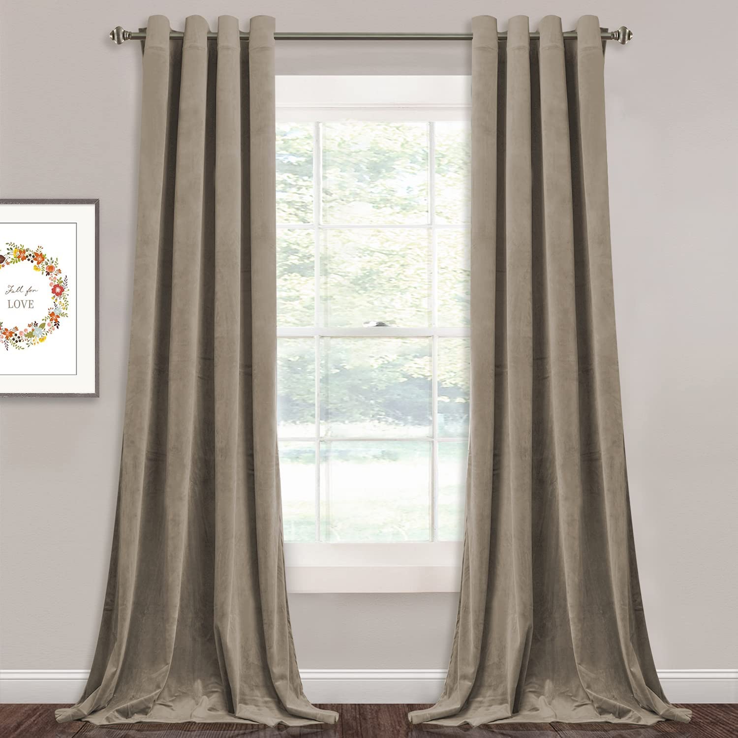 Neutral beige velvet blackout curtains with silver grommets, hung as two panels over a window, suitable for living room or bedroom.