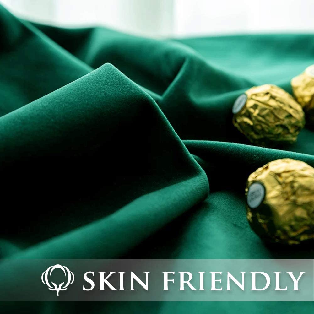 Close-up of dark green velvet blackout curtain fabric showcasing its plush, skin-friendly texture, perfect for living room and bedroom.