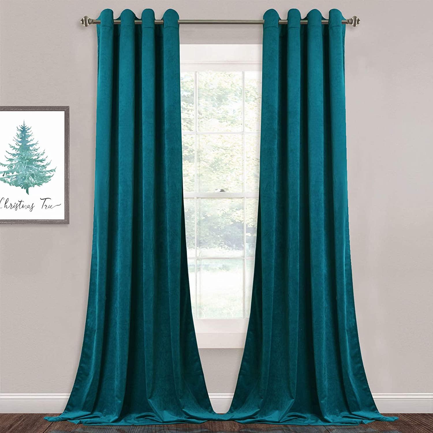 Two teal velvet blackout curtain panels with silver grommets, open in a living room or bedroom window.