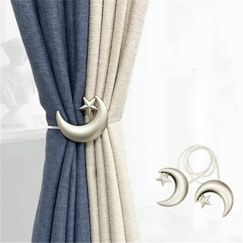 Silver metal magnetic star moon curtain tieback cinching blue & beige curtains; two tiebacks with straps displayed.