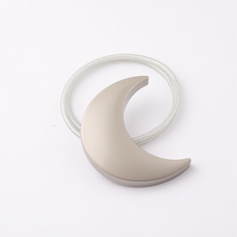 Single matte grey moon magnetic curtain tieback with silver braided strap for secure outdoor patio curtain decor.
