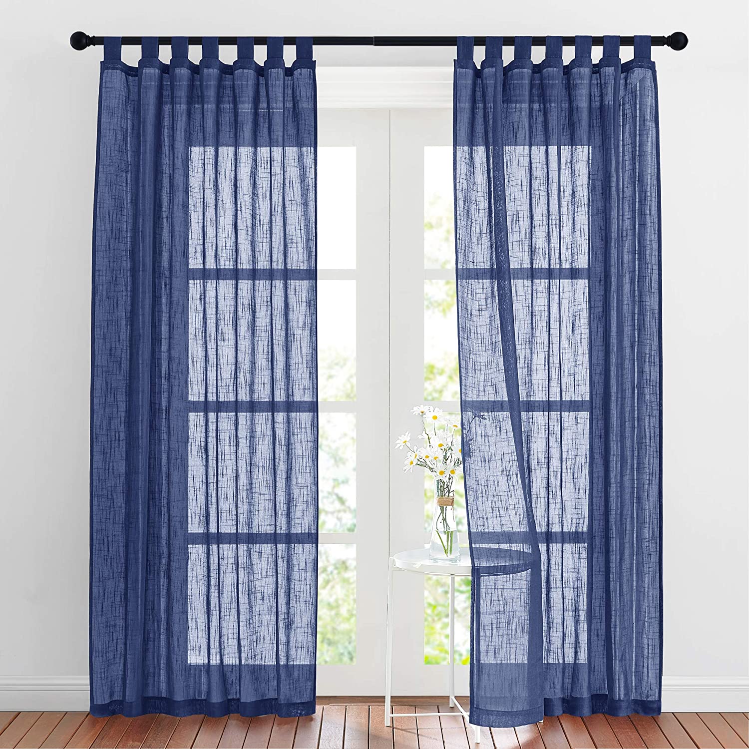 Two navy blue tab top sheer linen blend privacy curtains for bedroom or living room windows, softly filtering light.