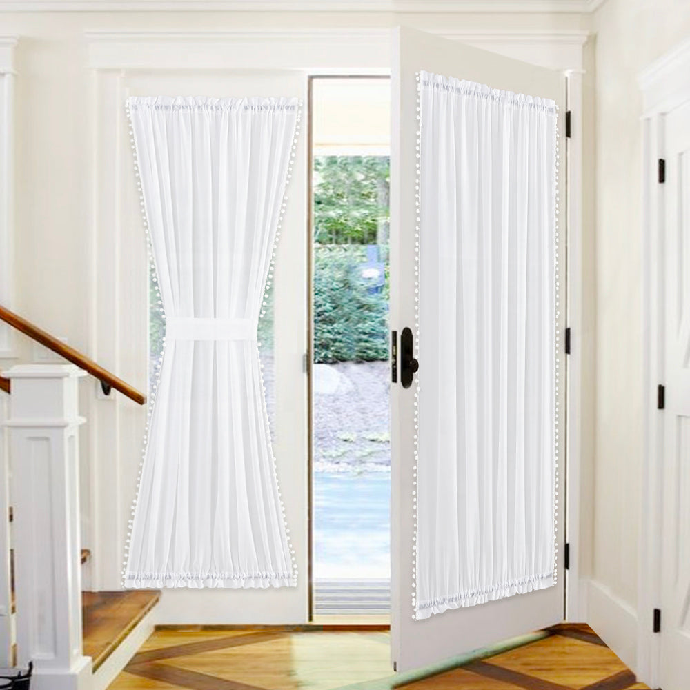 White sheer rod pocket pom pom door curtains with tiebacks, offering privacy for glass doors and sidelights.