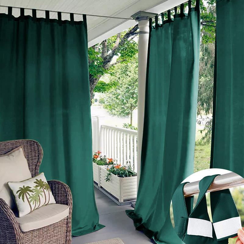 Emerald green waterproof outdoor curtains with Velcro tab tops on a patio, providing privacy and weather protection. Inset shows tab.