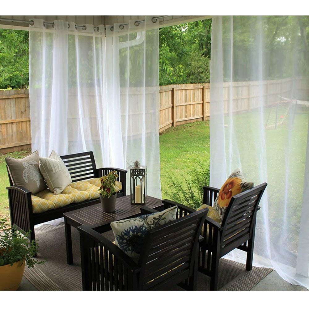 White grommet waterproof privacy outdoor sheer curtains enclosing a patio seating area with dark wood furniture and green backyard.