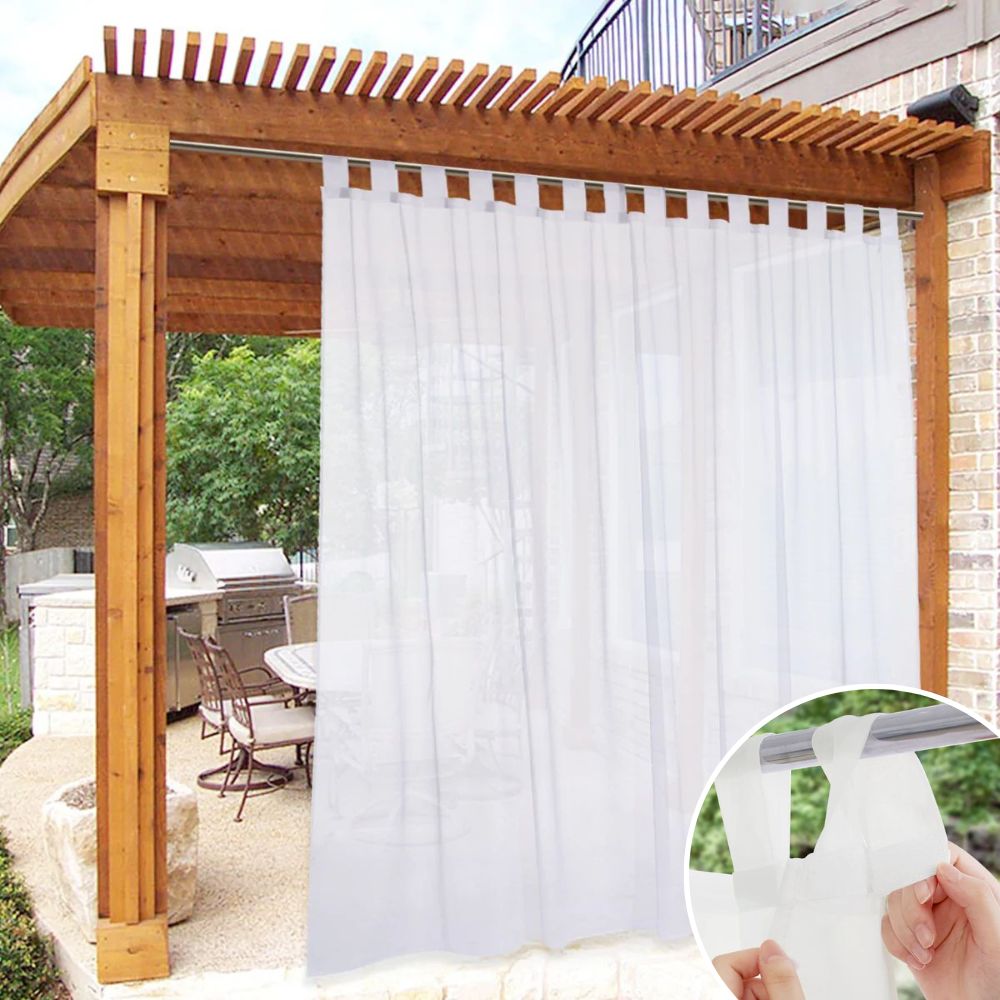 White waterproof decorative outdoor sheer curtain with Velcro tab top on a wooden pergola, creating a private patio.